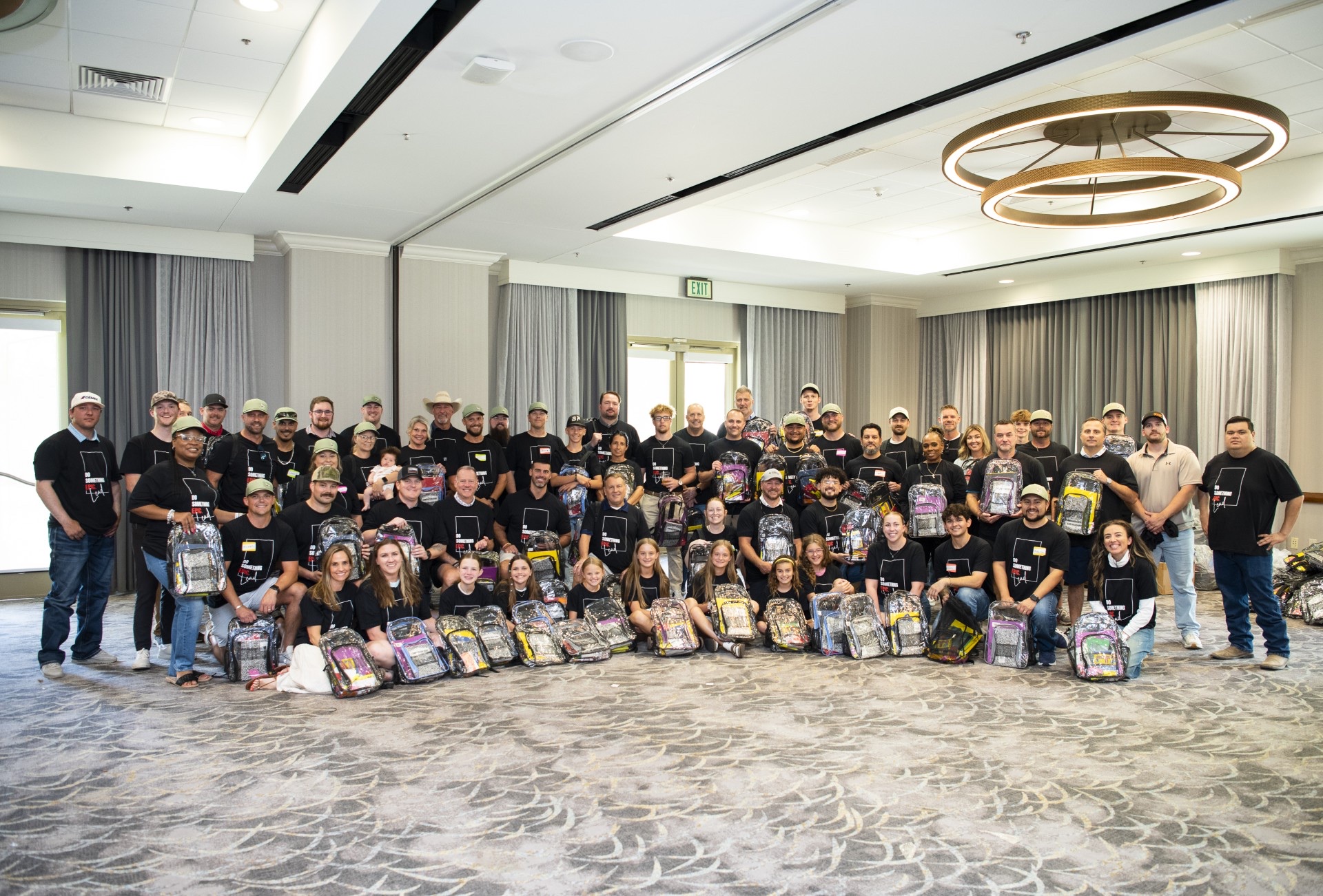TACA Emerging Leaders Academy members and volunteers with the backpacks they packed at TACA's 2026 Annual Meeting