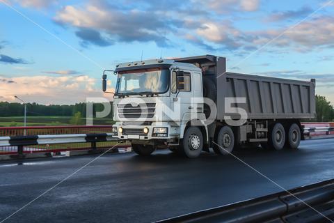 An aggregate dump truck hauling construction materials on a rural Texas road