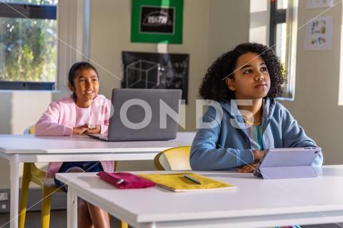 A teacher working with students in a modern Texas classroom