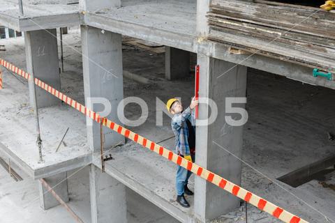 A friendly Texas aggregate industry worker in a hard hat and safety vest