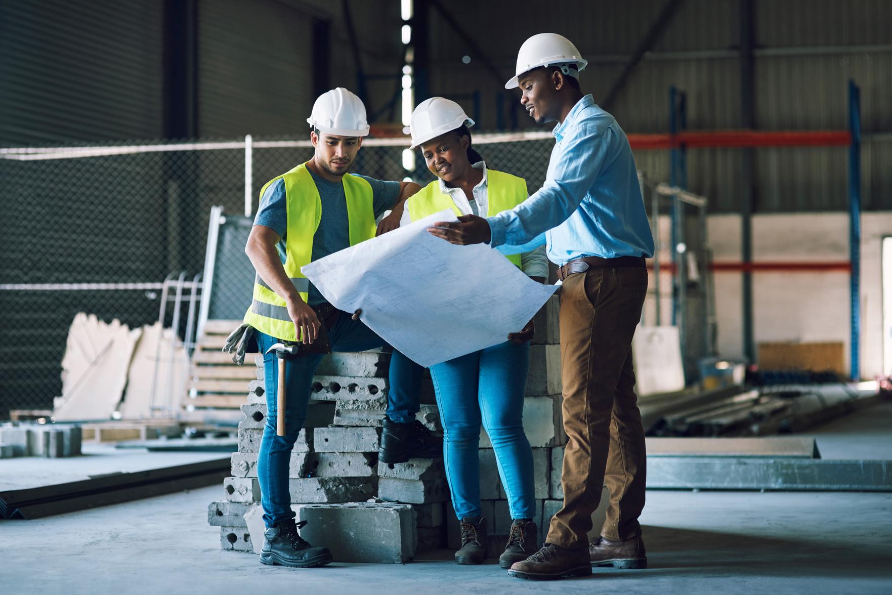 Texas construction professionals reviewing building plans on site